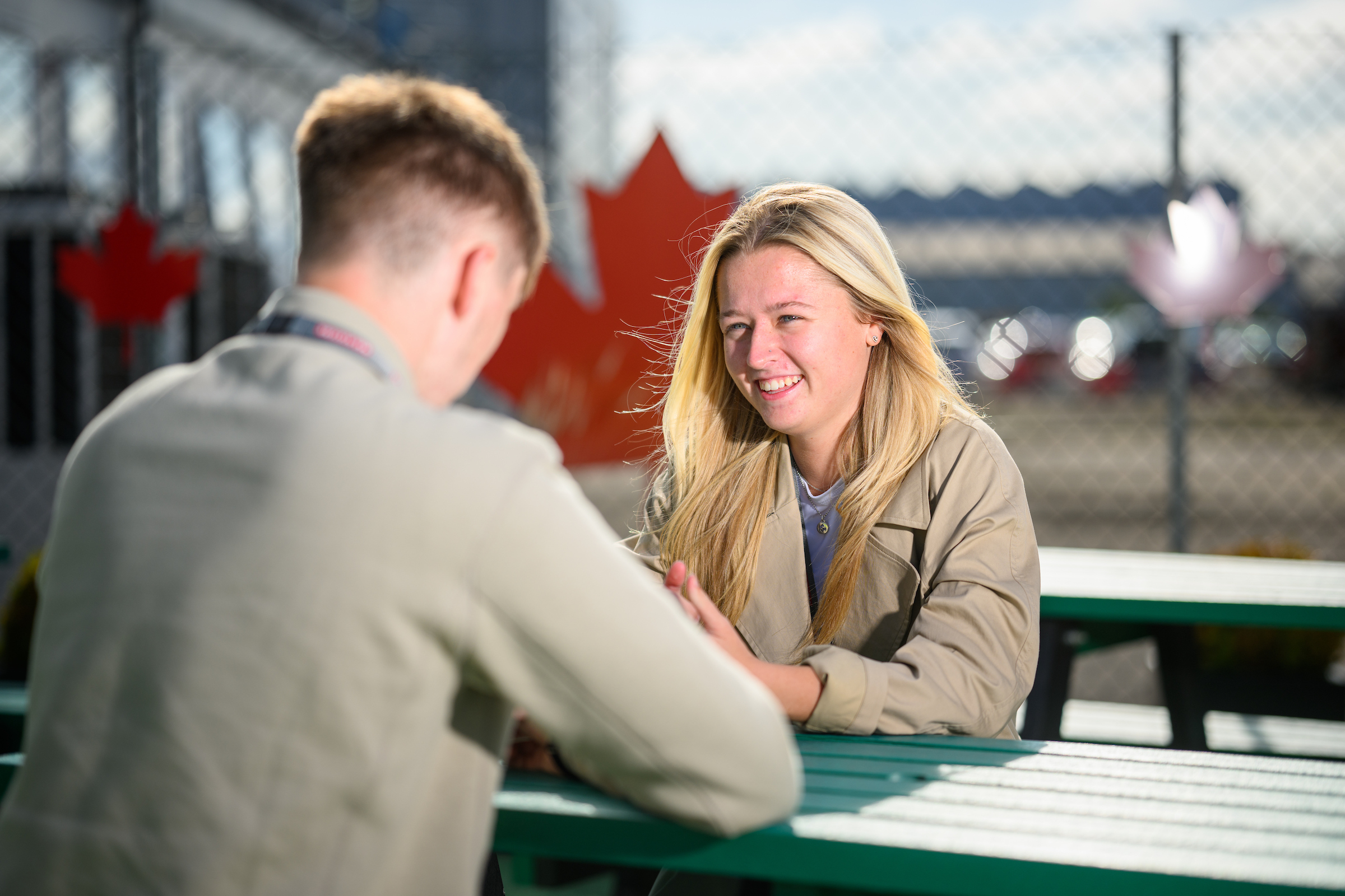Two colleagues seated outside talking