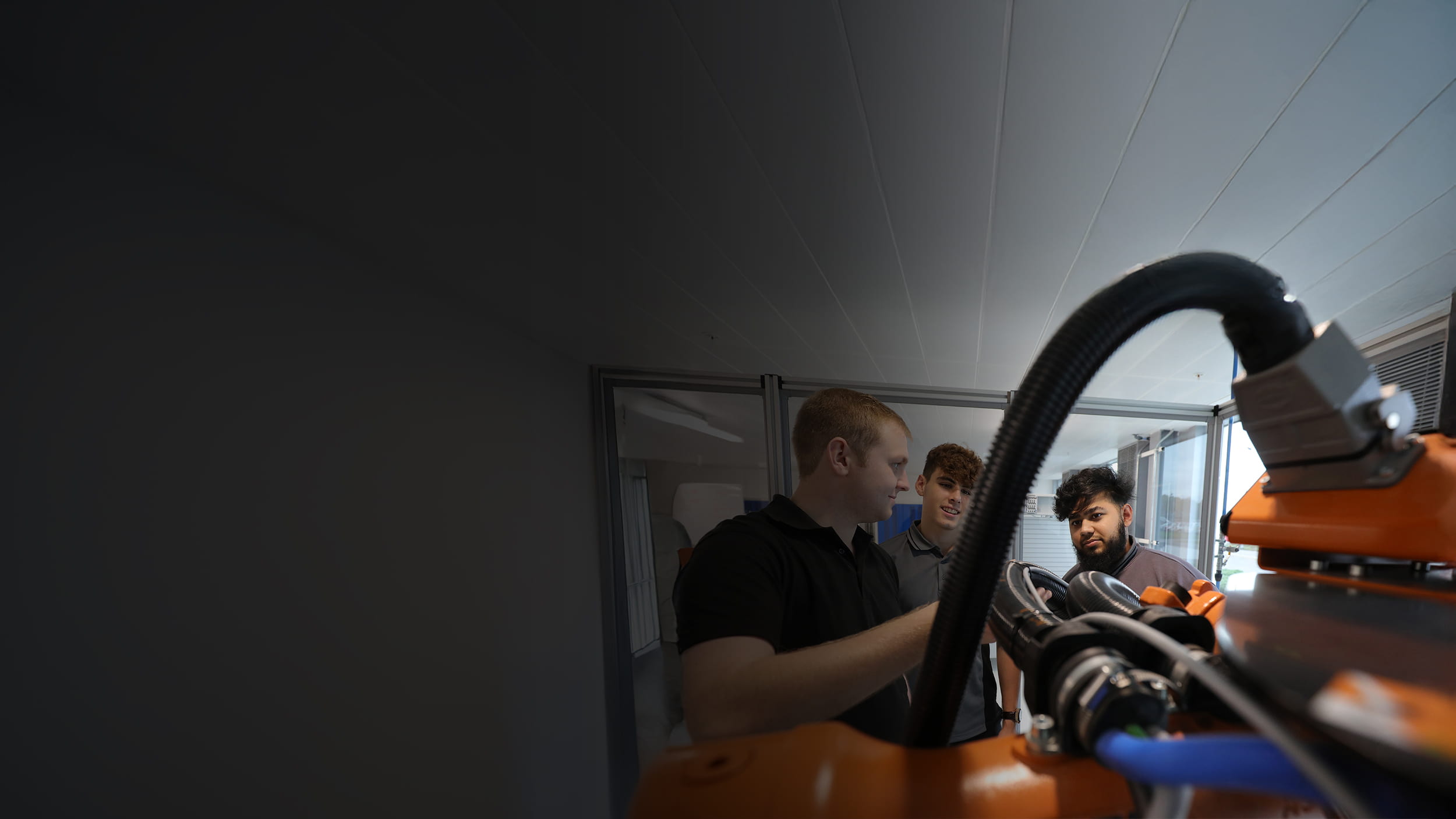 Two employees getting complex machinery explained to them