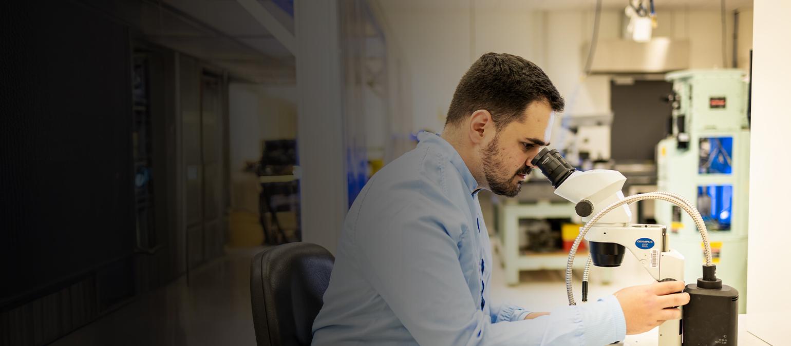 Man looking through microscope