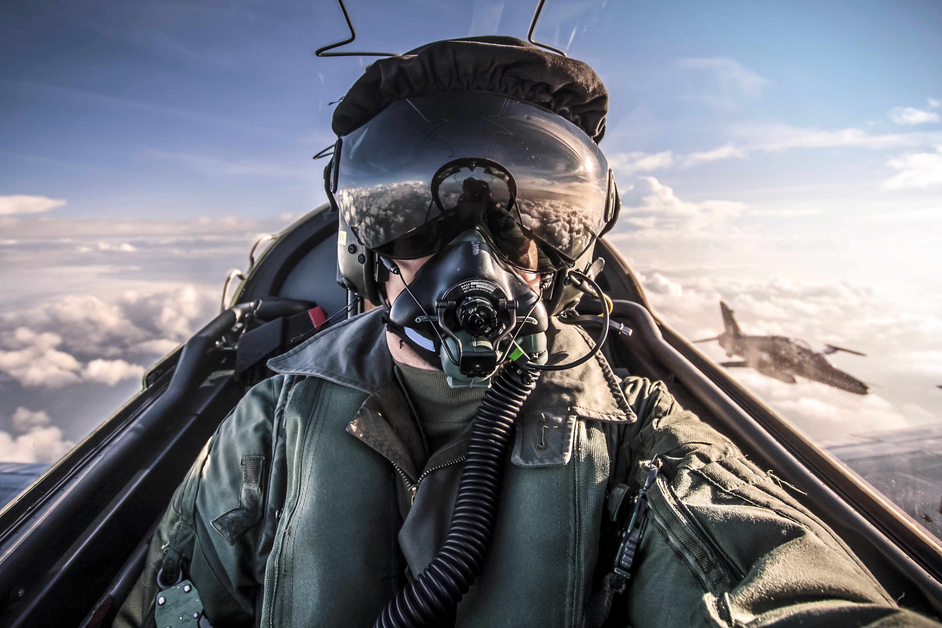 A pilot in the cockpit of an aircraft operated by the Royal Air Force.