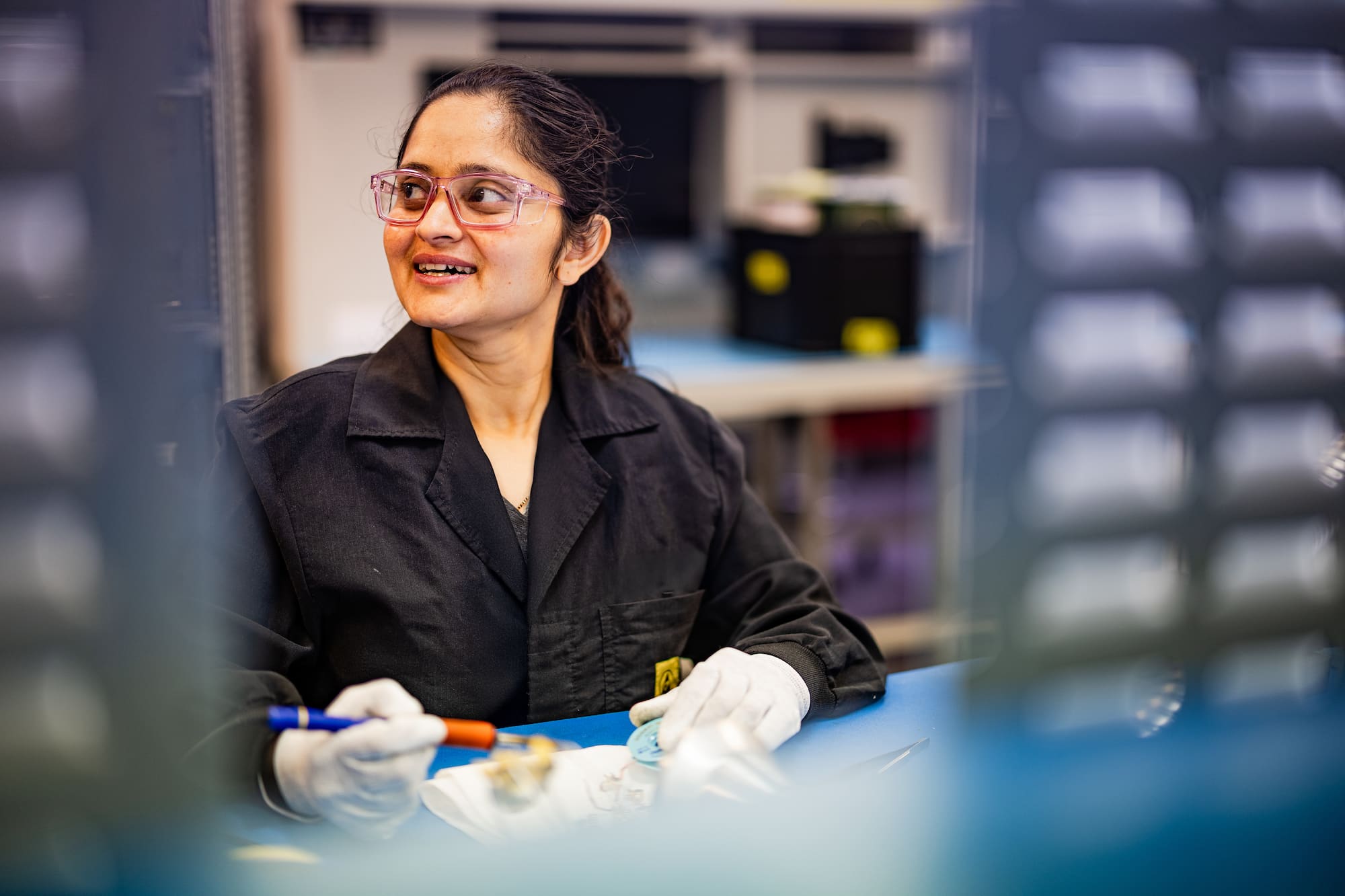 Young woman working on soldering electronics in workshop
