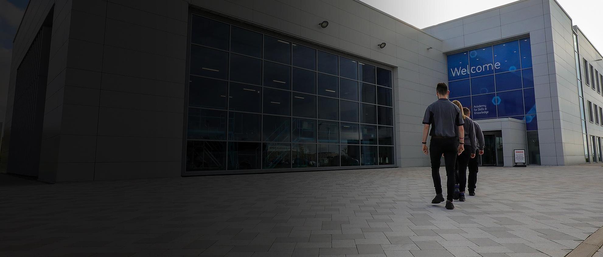 Employees walking into a building