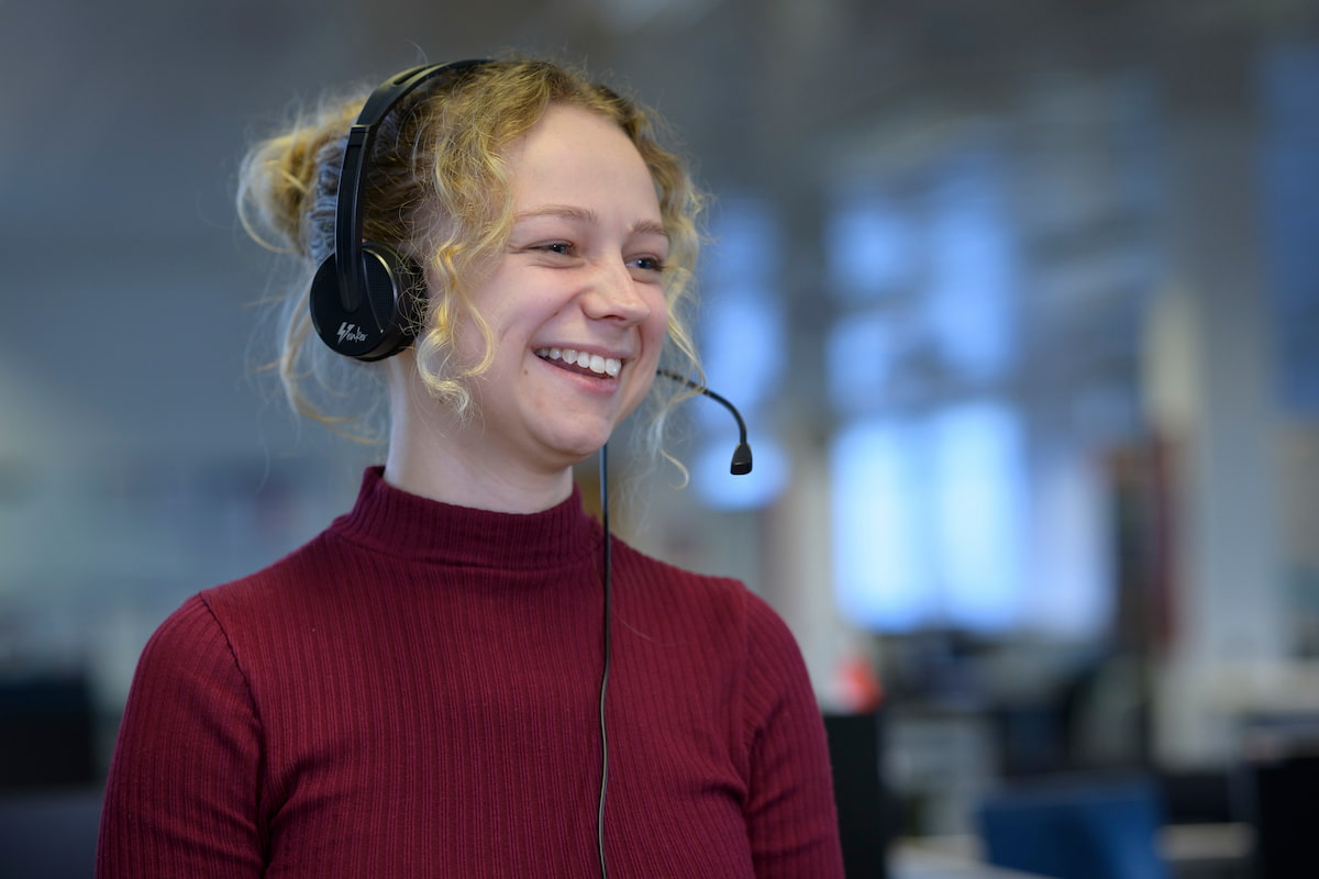 Smiling womn wearing a headset