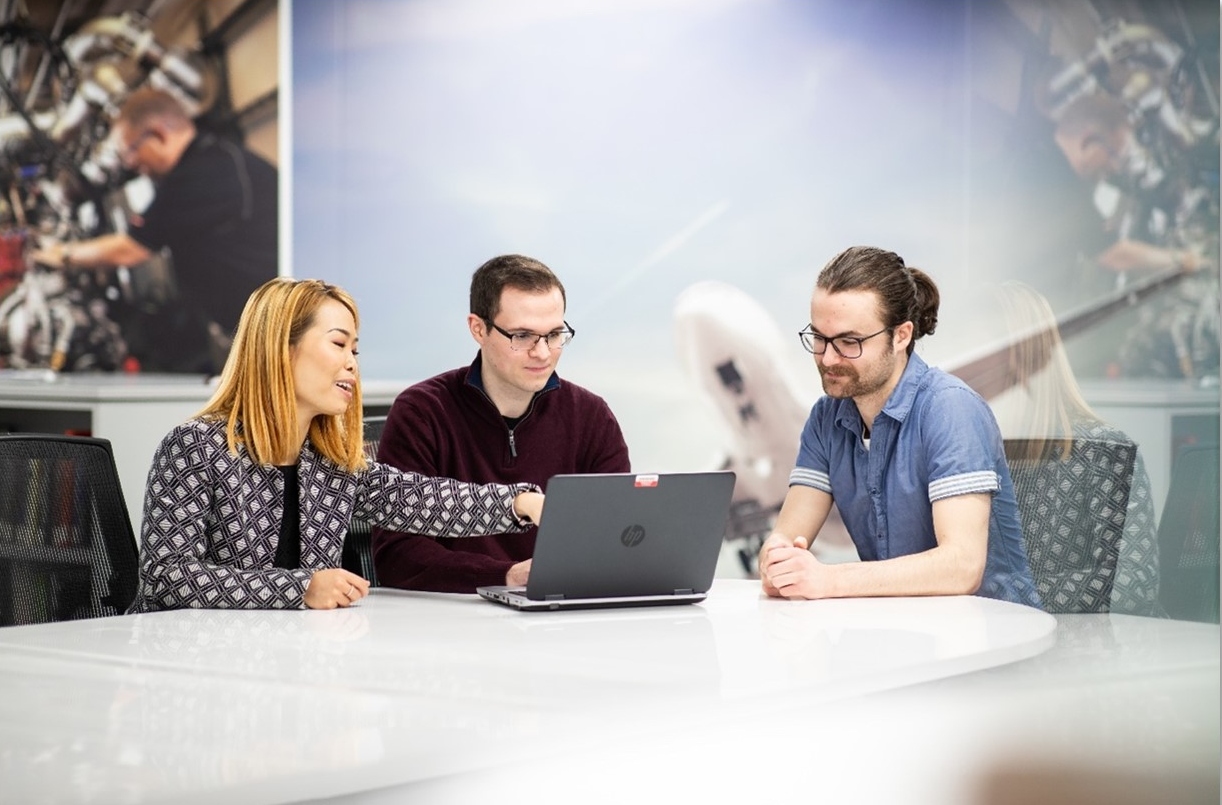 Three higher level apprentices sit around a table having a meeting at BAE Systems